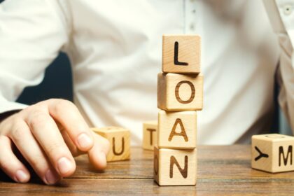 Wooden blocks with the word loan and businessman