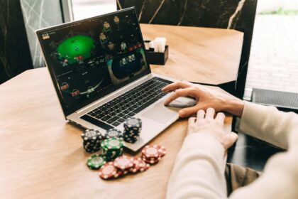 Young man play online poker in laptop.