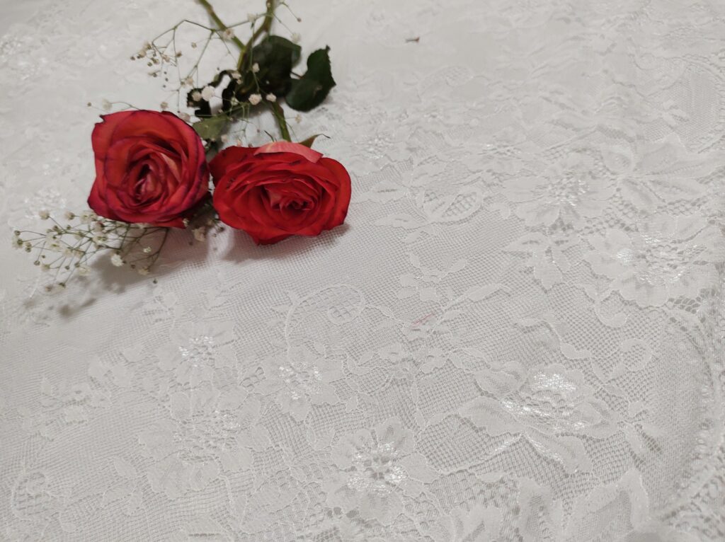 red roses on white floral textile