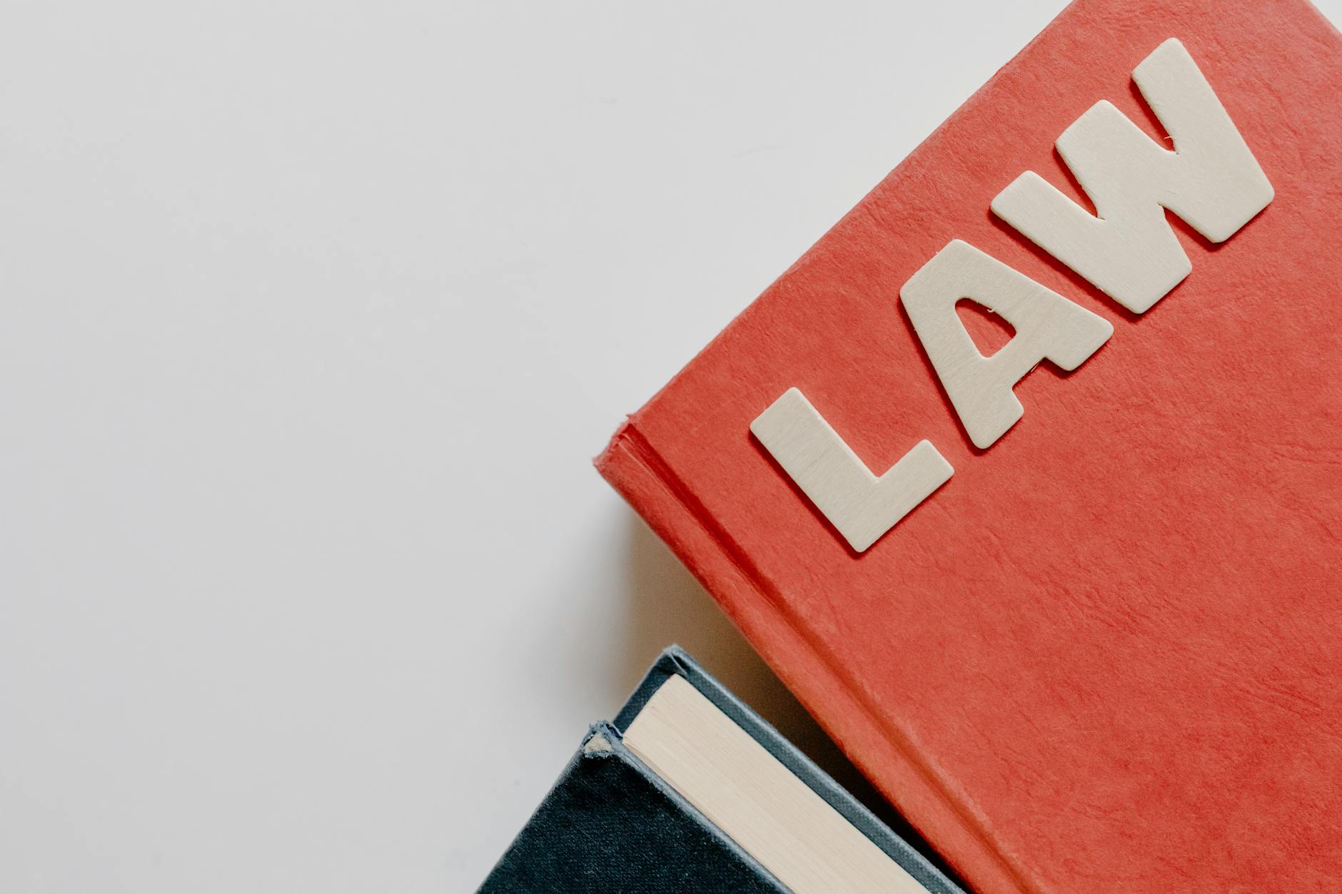 Essential Elements of Tort Law for 2026 Exams (Red law textbook and dark book on white background, symbolizing education.)