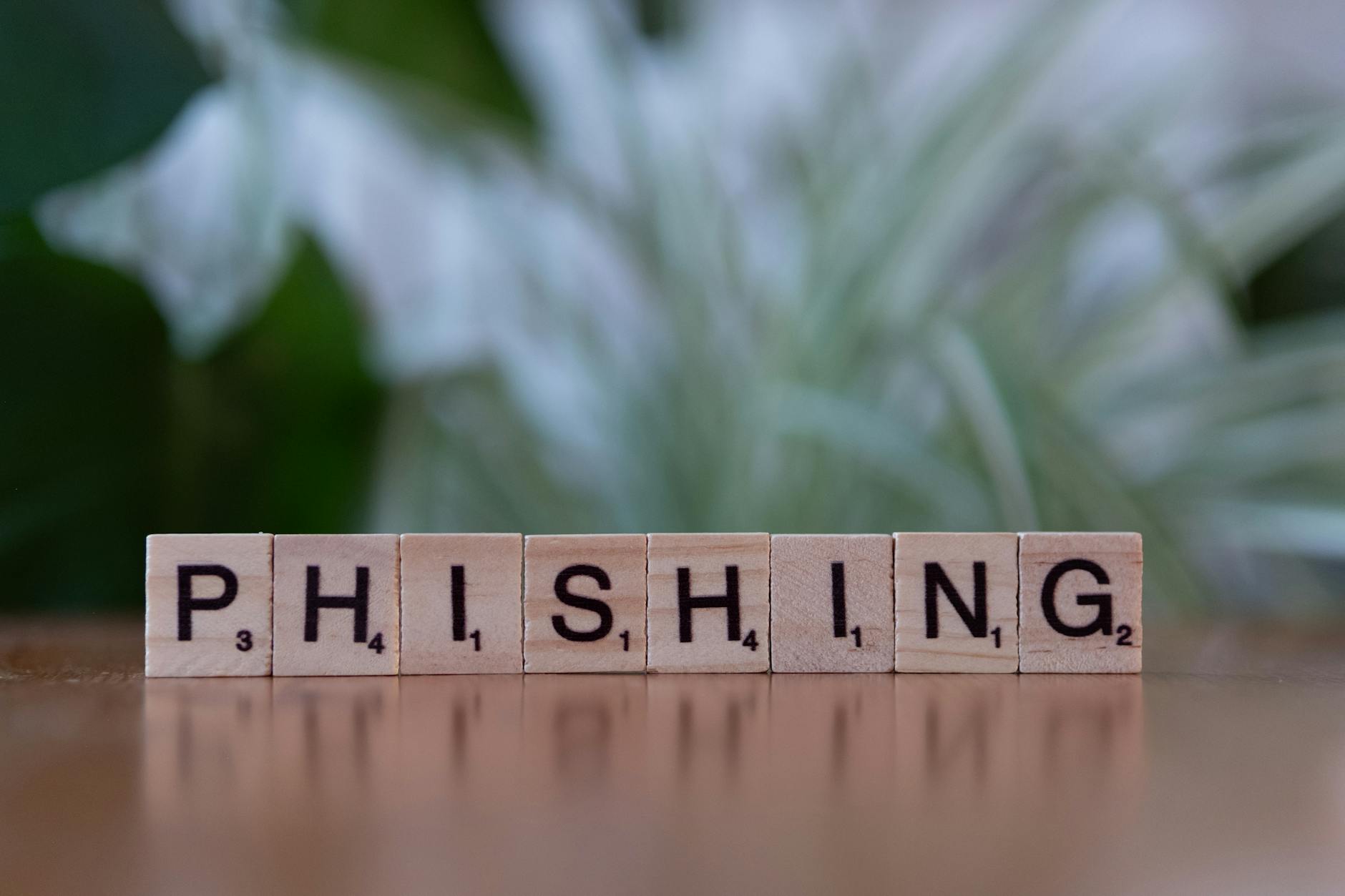Malicious Prosecution Elements for Law Students (Wooden tiles spelling 'phishing' highlight cybersecurity themes.)