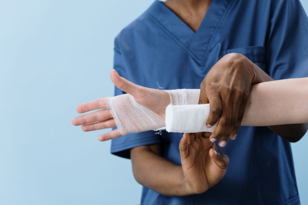 A medical professional carefully wrapping a bandage around an injured person's hand. Understanding Your Personal Injury Rights Under US Law