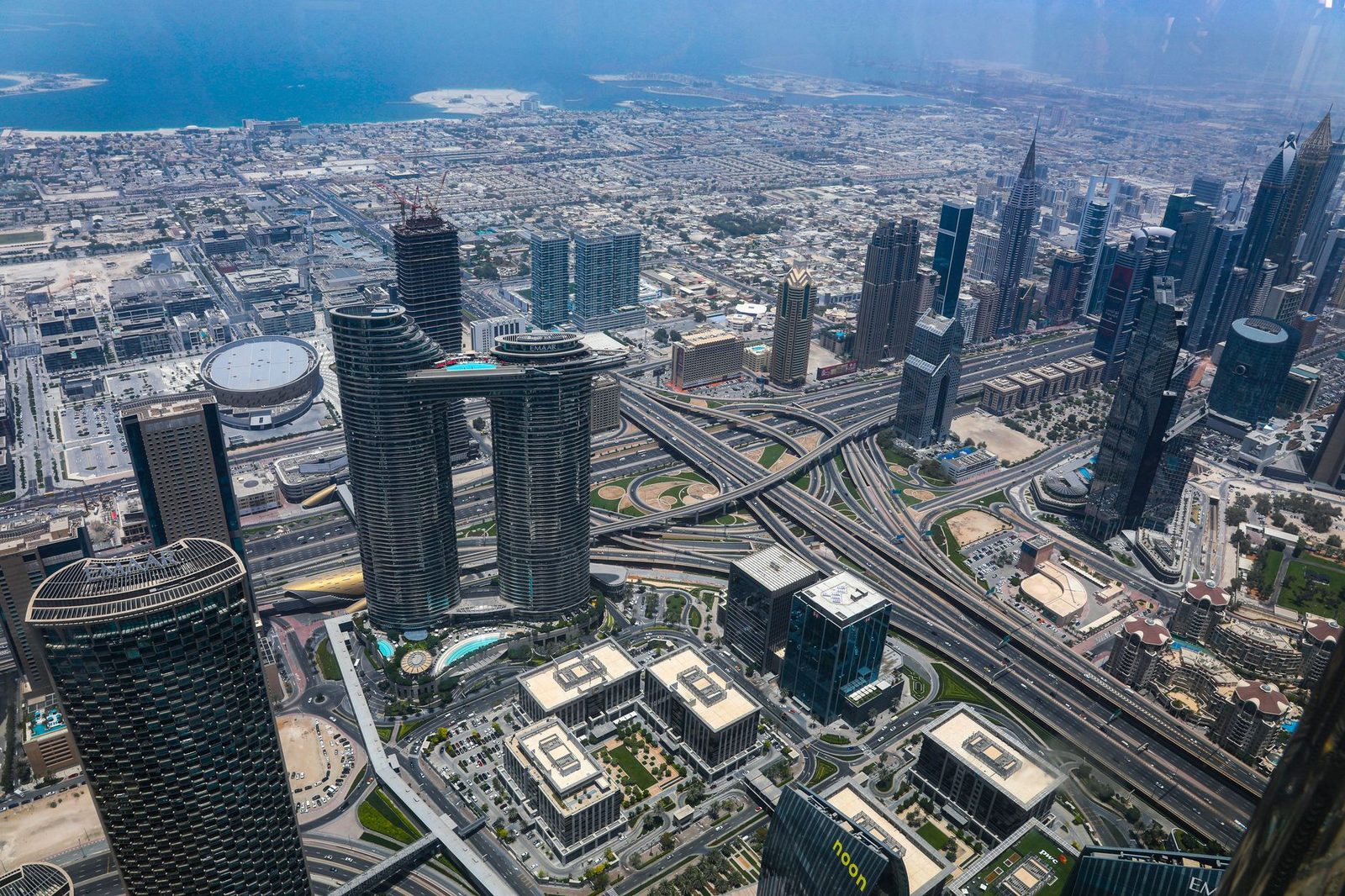 Stunning aerial shot of Dubai's modern skyline with high-rise buildings and intricate road network.