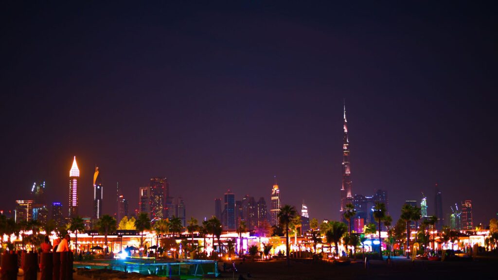 Stunning view of Dubai's illuminated skyline at night featuring the Burj Khalifa.