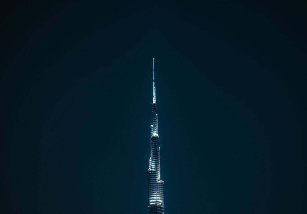 Night view of the illuminated Burj Khalifa in Dubai, showcasing its modern architecture.