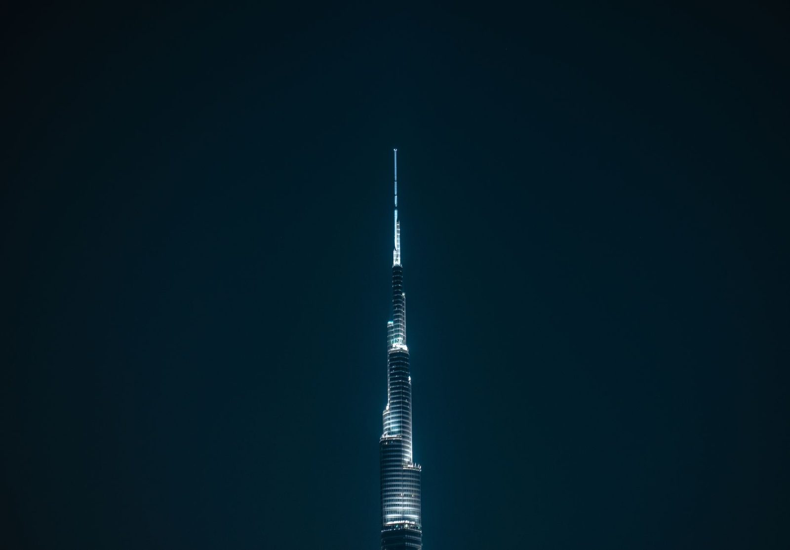 Night view of the illuminated Burj Khalifa in Dubai, showcasing its modern architecture.