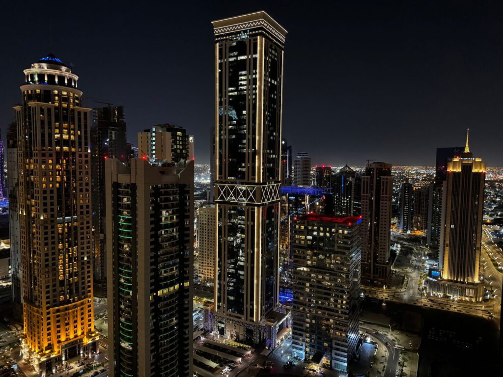 Discover the dazzling skyline of Dubai with towering skyscrapers illuminated against the night.