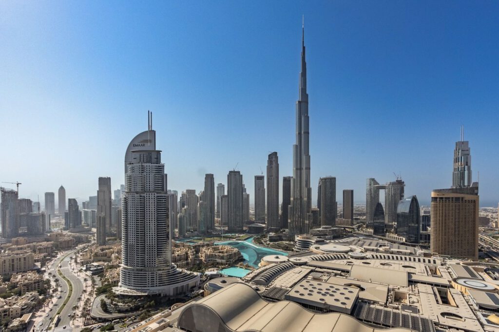 Stunning aerial view of Dubai's modern skyline featuring the iconic Burj Khalifa under a clear blue sky.