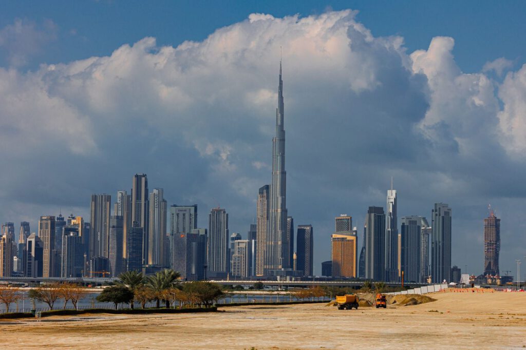 A breathtaking view of the Burj Khalifa towering over the stunning skyline of Dubai under dramatic clouds.