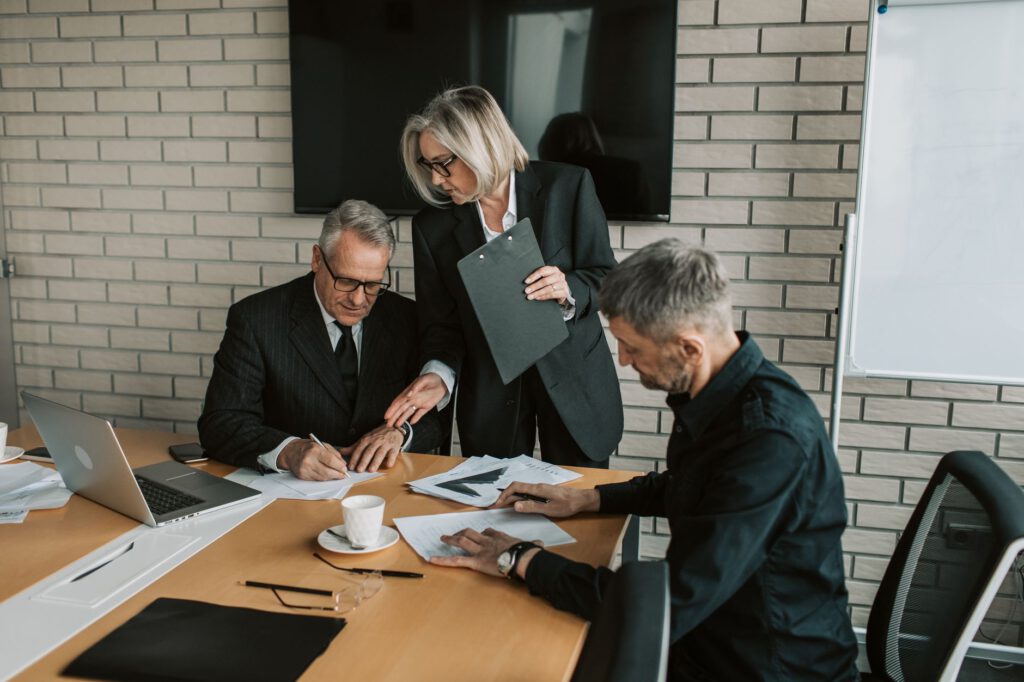 Corporate executive reviewing documents at a desk in a modern office