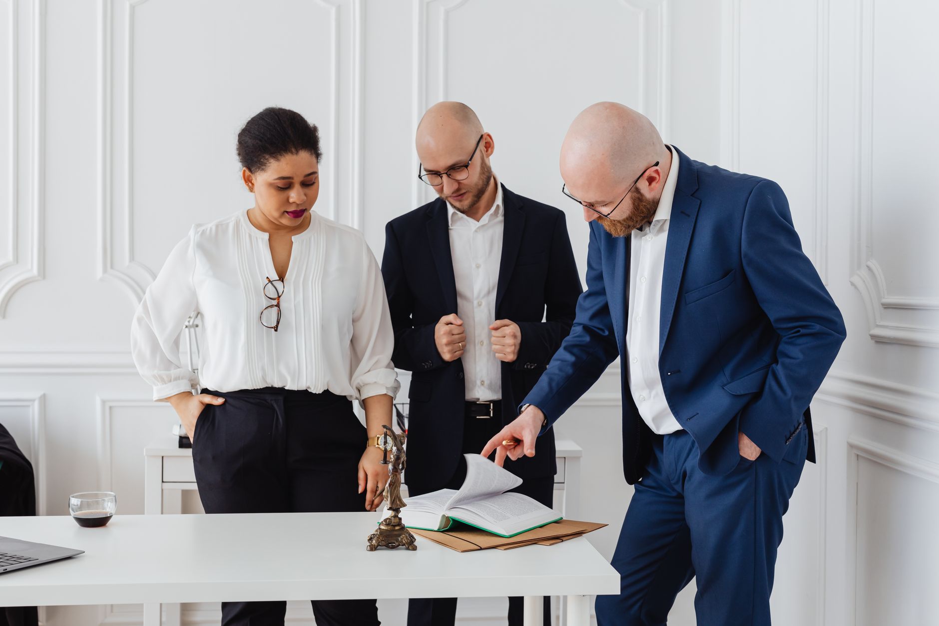 Corporate lawyers reviewing a deal document around a boardroom table