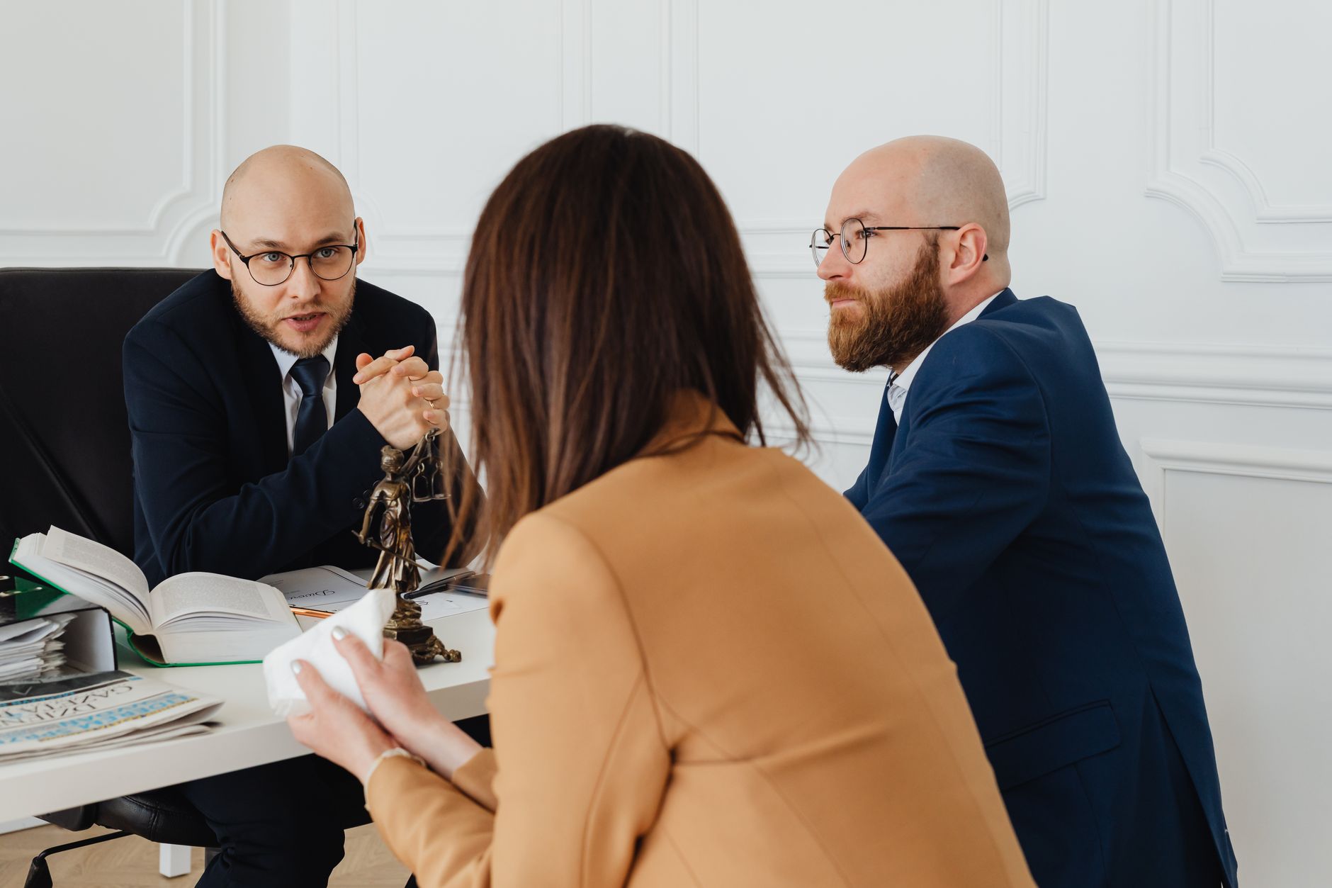 Young lawyer in a business suit reviewing case files during a meeting