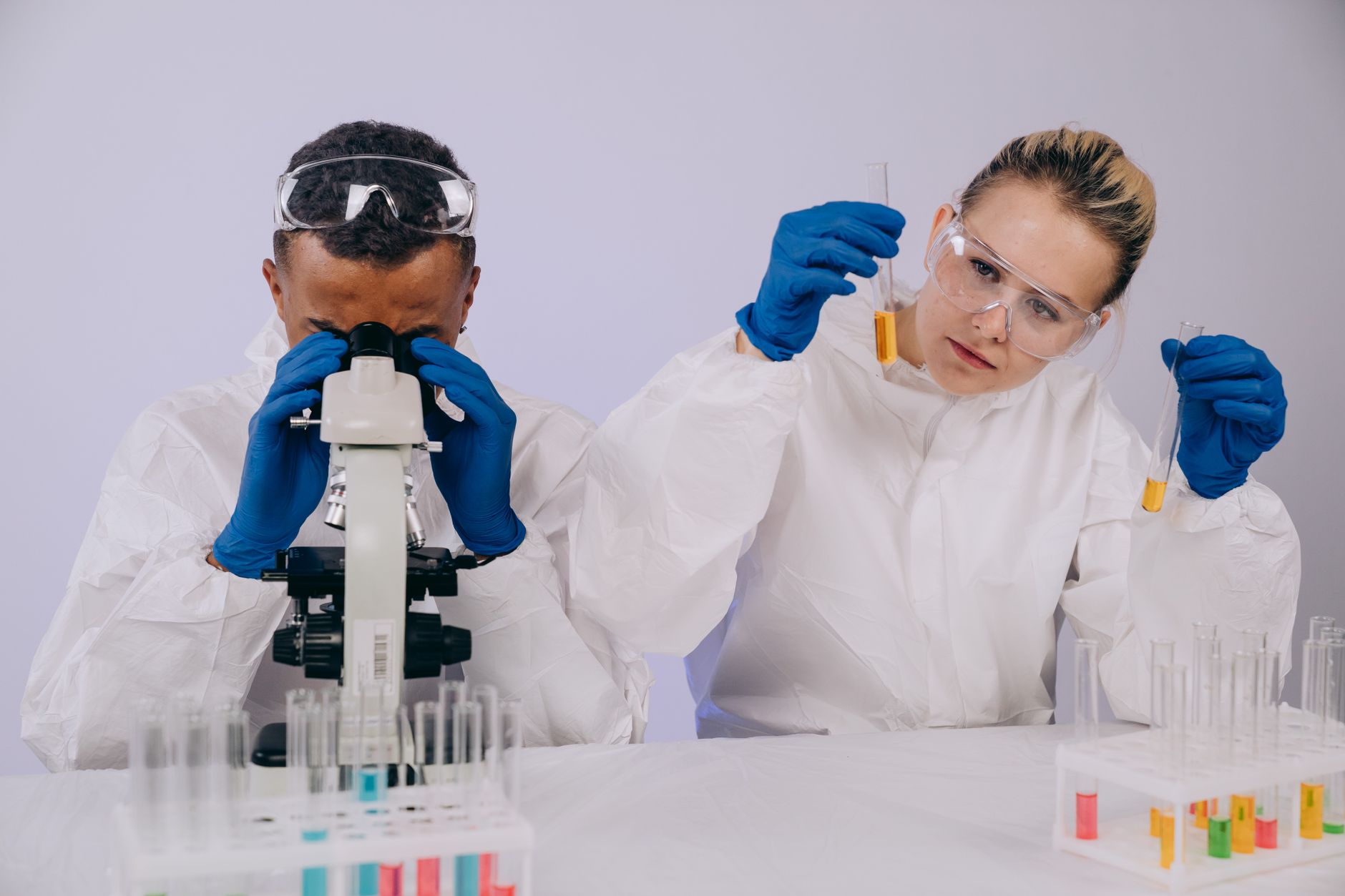 Forensic scientist in a laboratory examining evidence samples under bright lab lighting