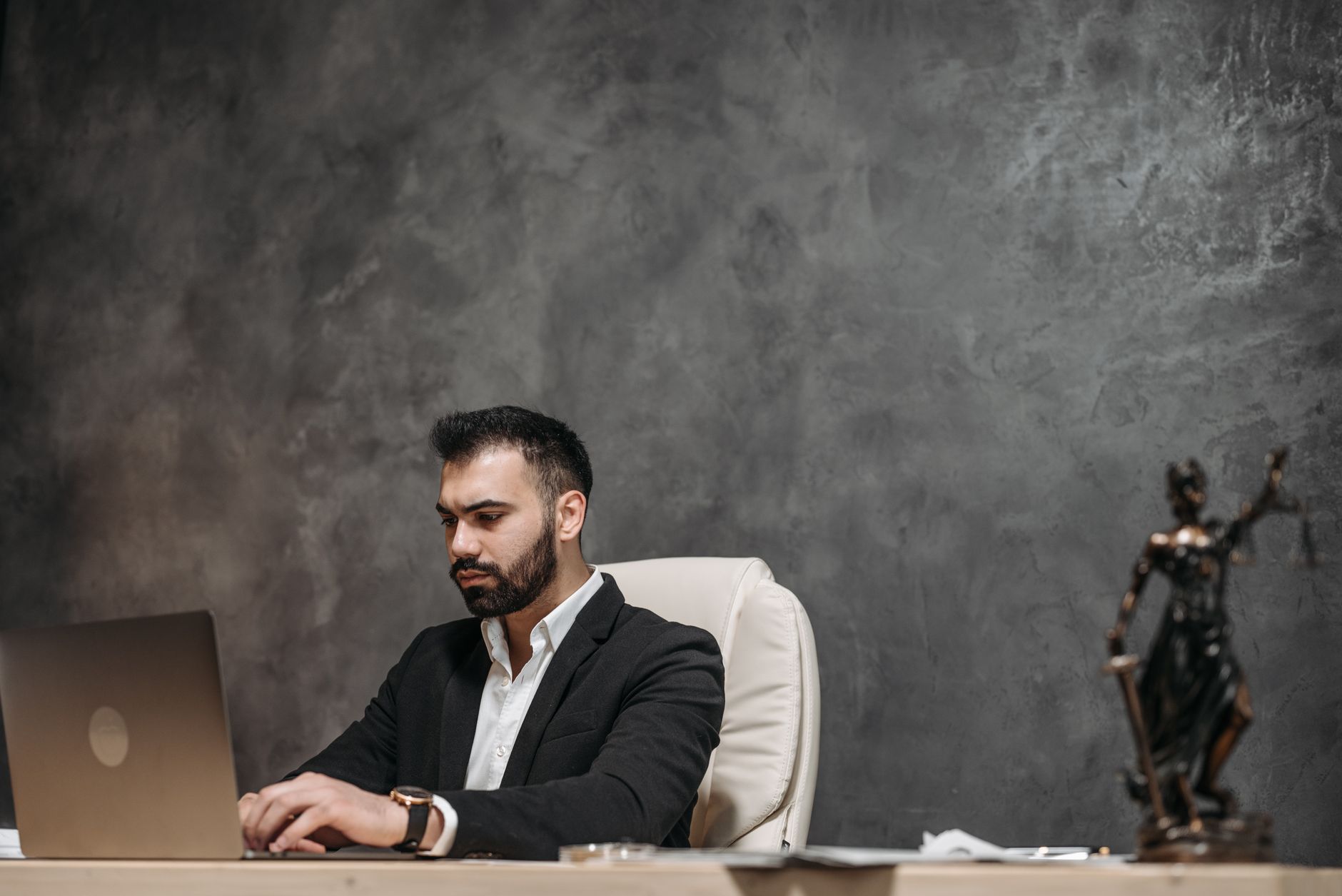 In-house lawyer working on a laptop in a corporate office
