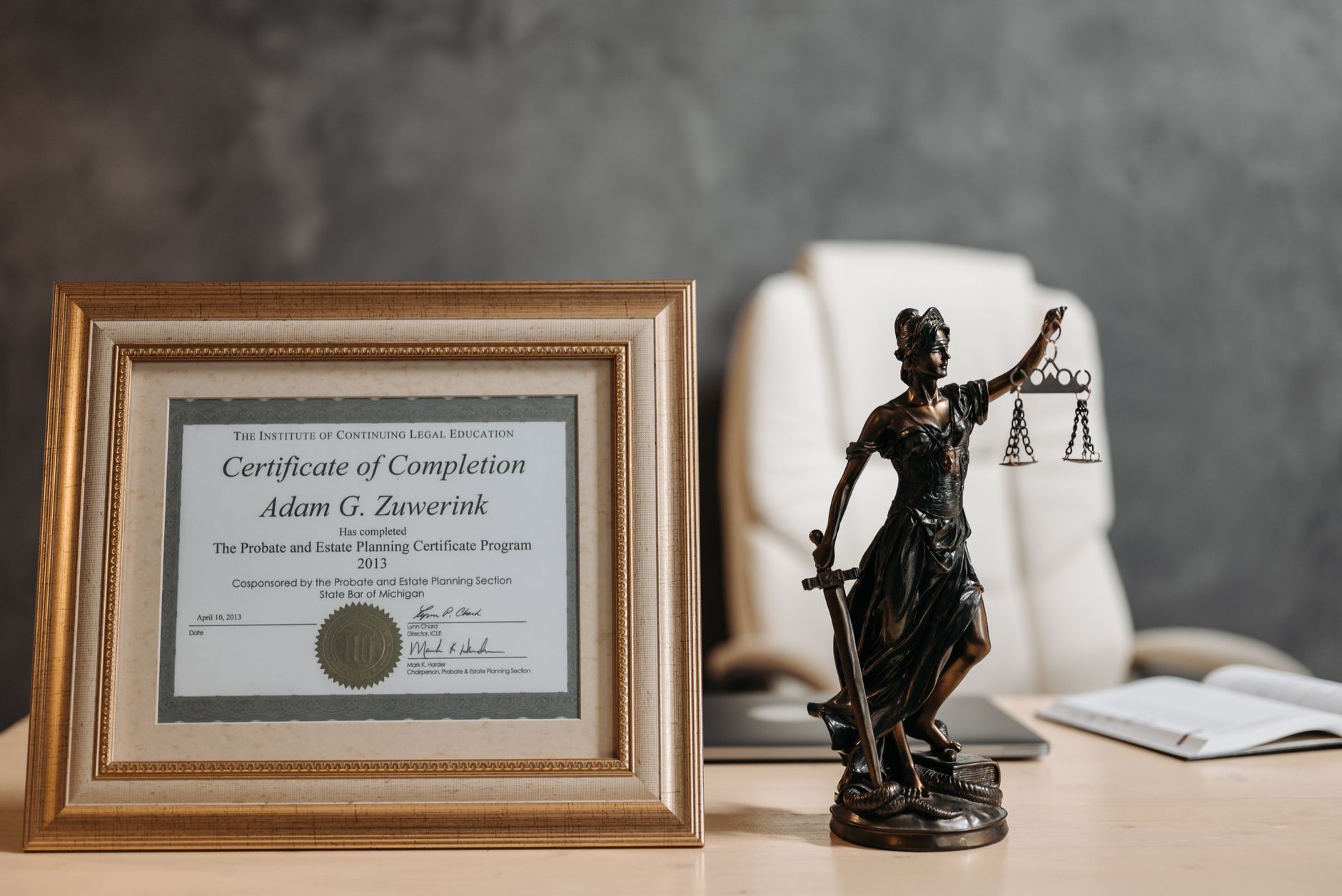 Lawyer working at a desk in a law office with legal documents and a laptop