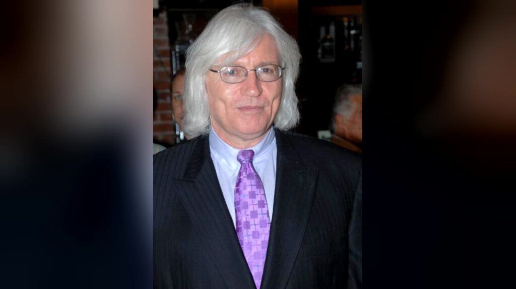 Los Angeles trial lawyer Thomas Mesereau with white hair and glasses, wearing a pinstripe suit
