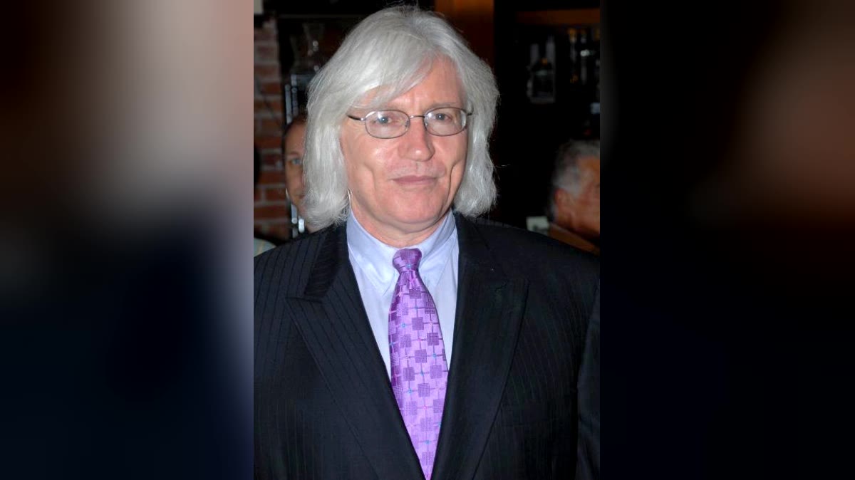 Los Angeles trial lawyer Thomas Mesereau with white hair and glasses, wearing a pinstripe suit