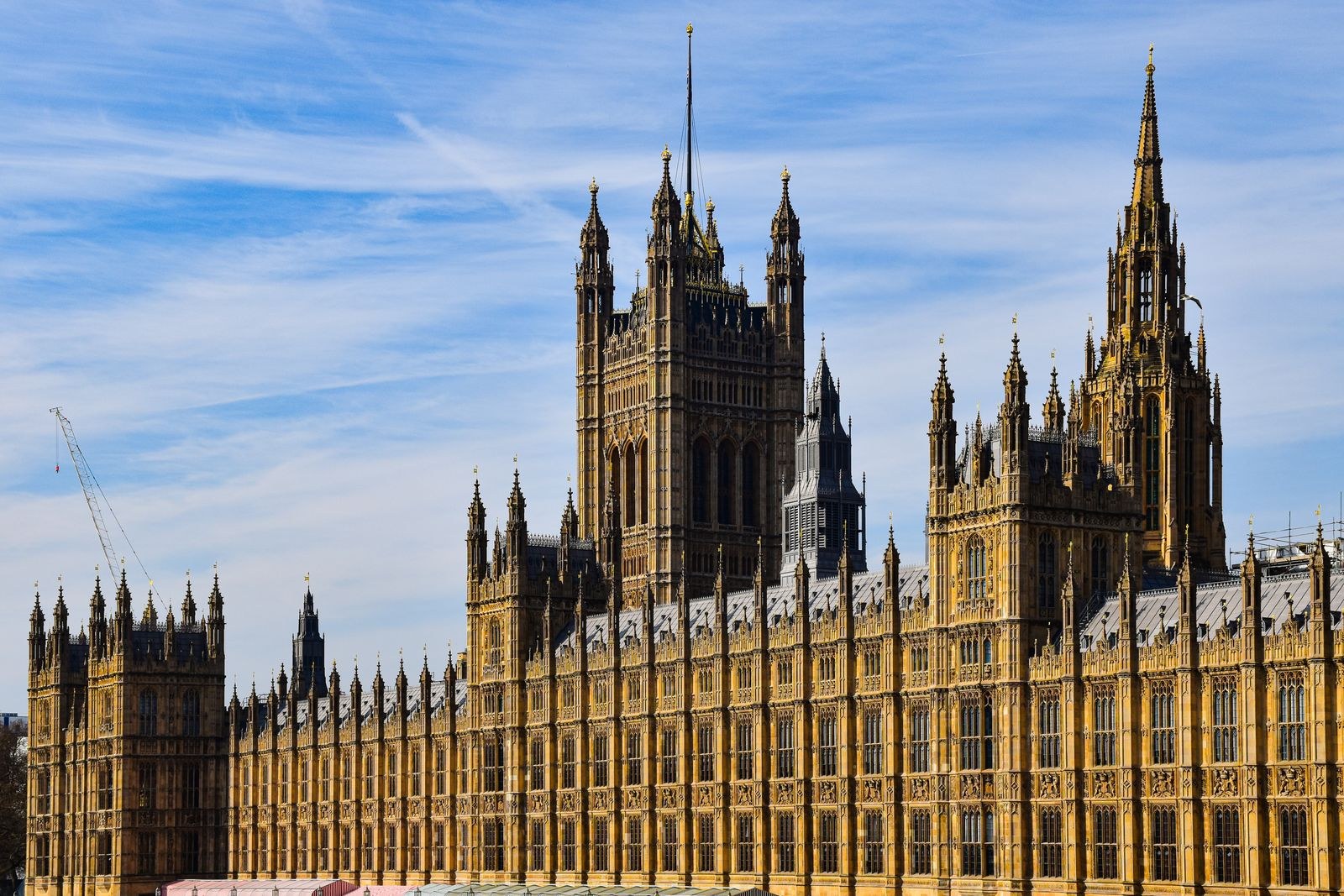 The Palace of Westminster in London, home of the UK Parliament, under a blue sky