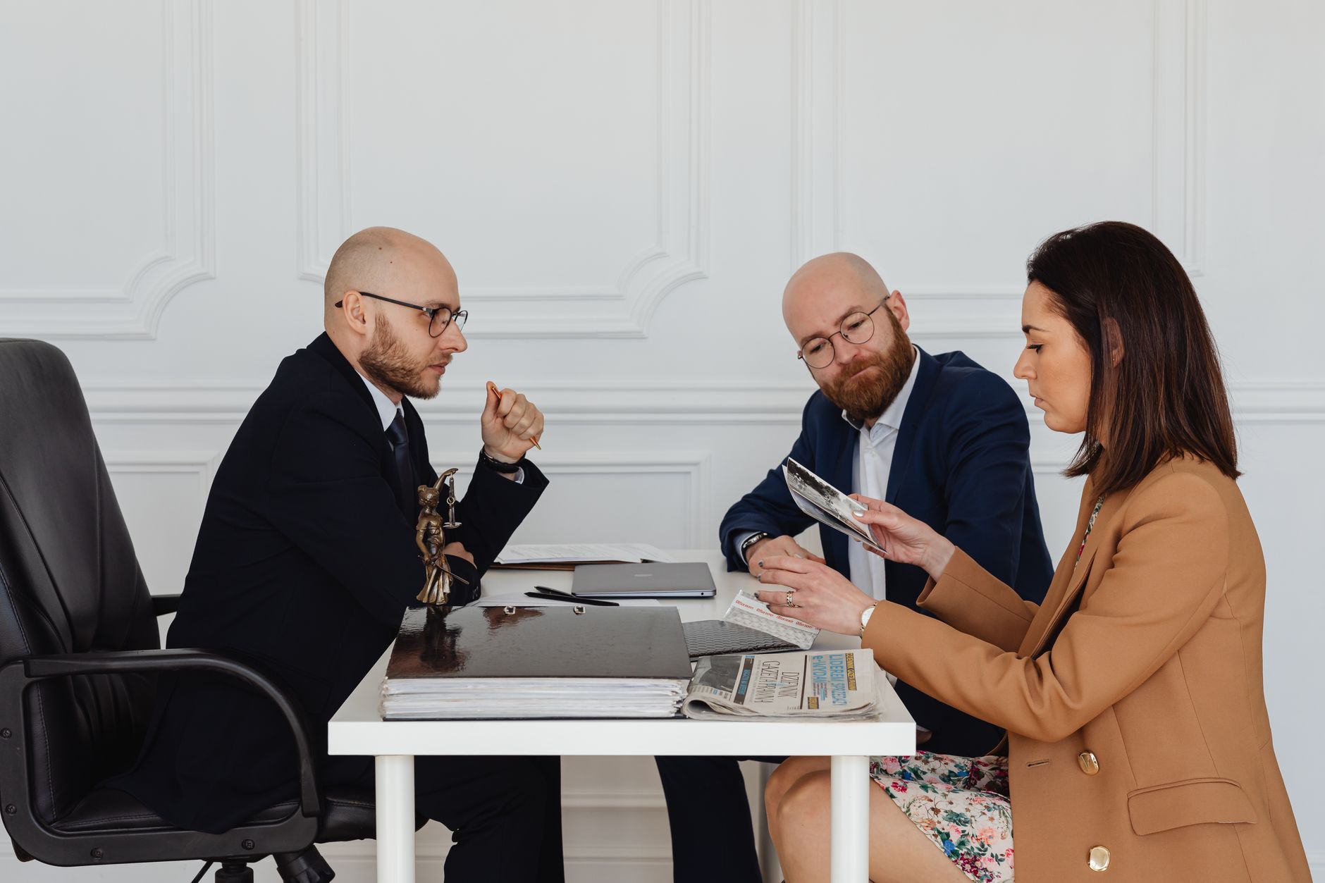 Paralegal organising legal files beside a lawyer in a law office